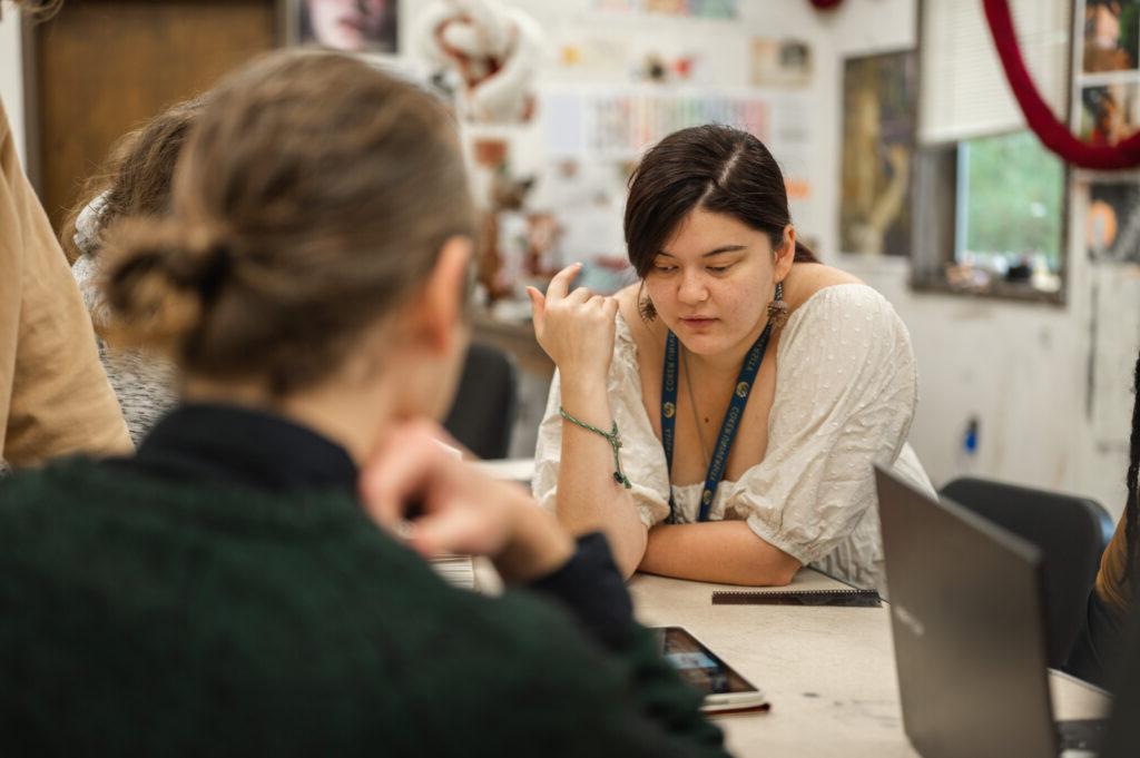 Two students work on assignments in class